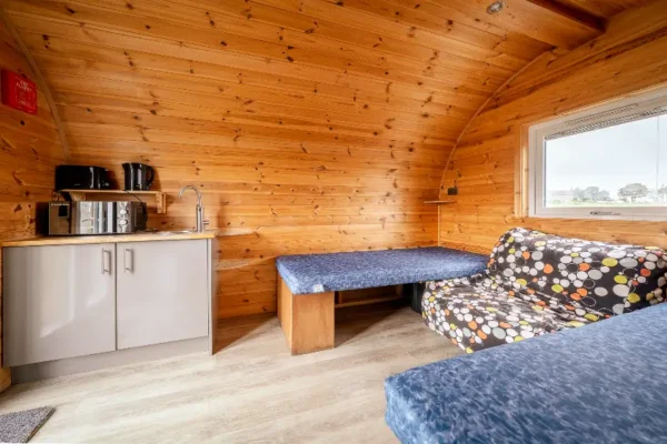 Kitchenette and beds inside a pod